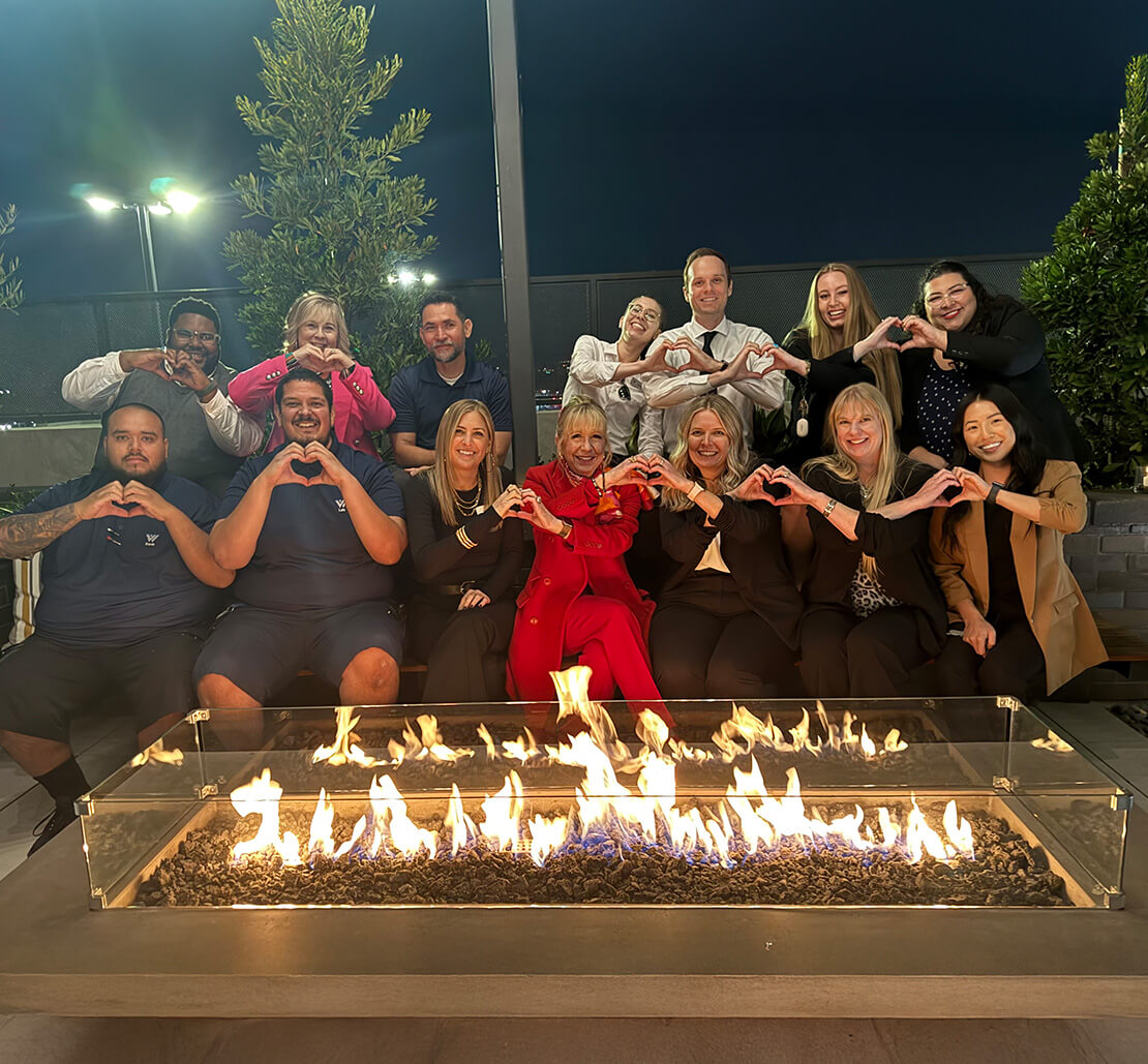 a group photo in front of a fireplace